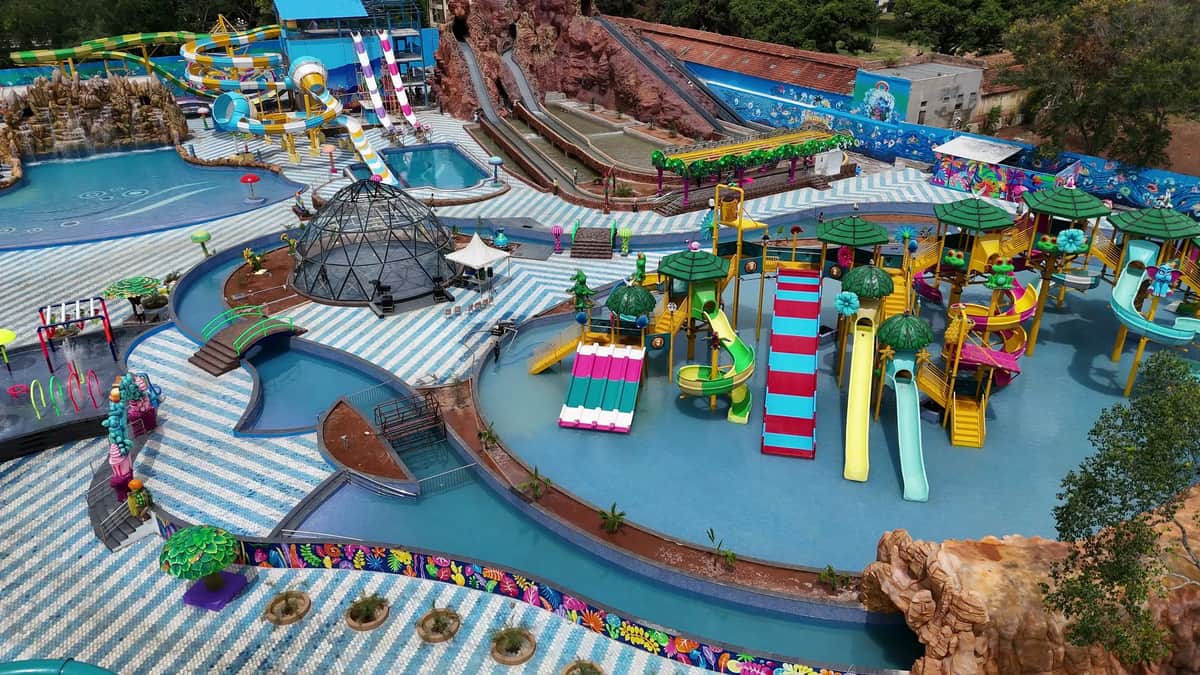 Aerial view of the kids' island, lazy river, slide towers and rock mountain