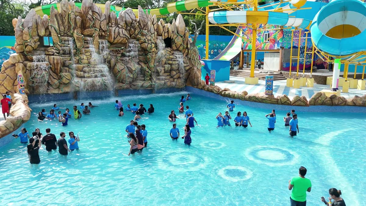Guests in the lagoon beneath the rock waterfall